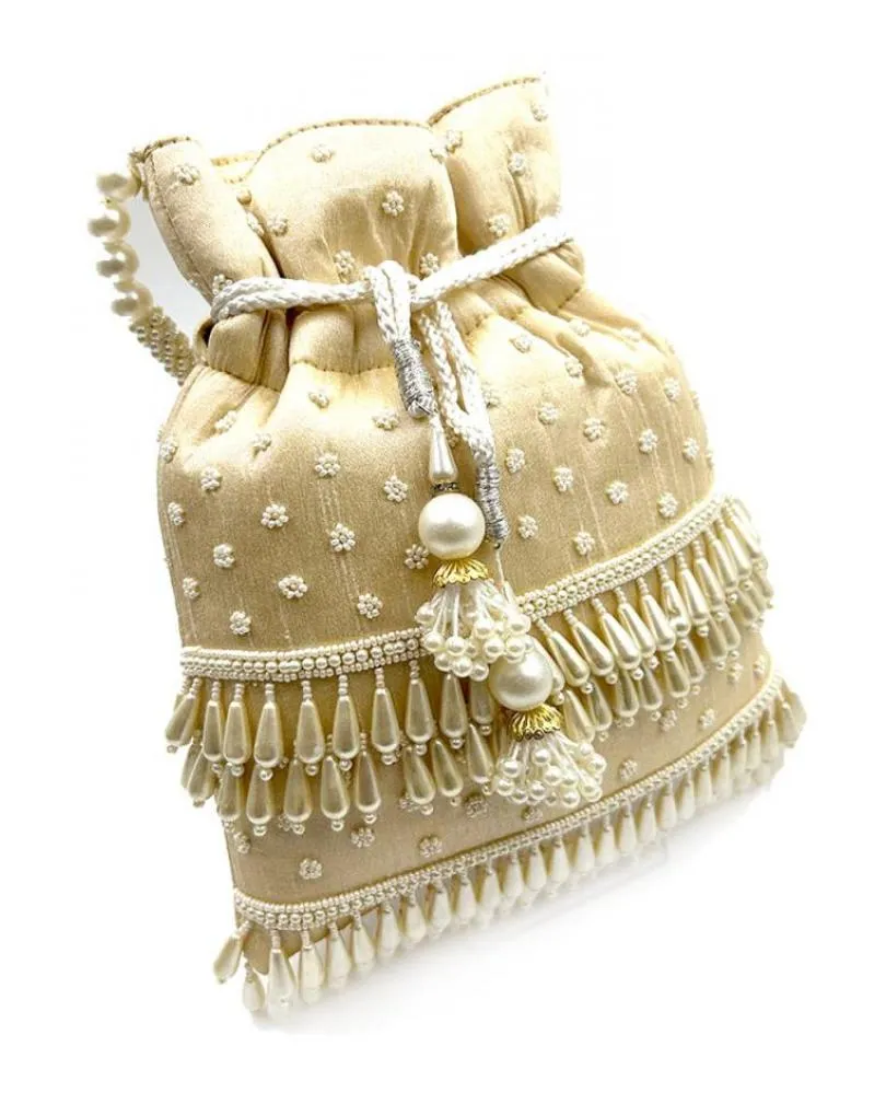 Beige wedding purses with beautiful pearl decoration.