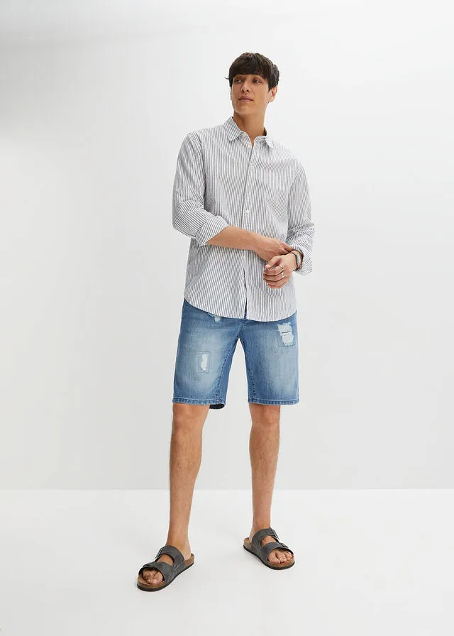 Denim Bermuda shorts with stretch waistband and distressed regular fit.