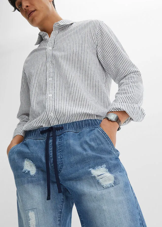 Denim Bermuda shorts with stretch waistband and distressed regular fit.