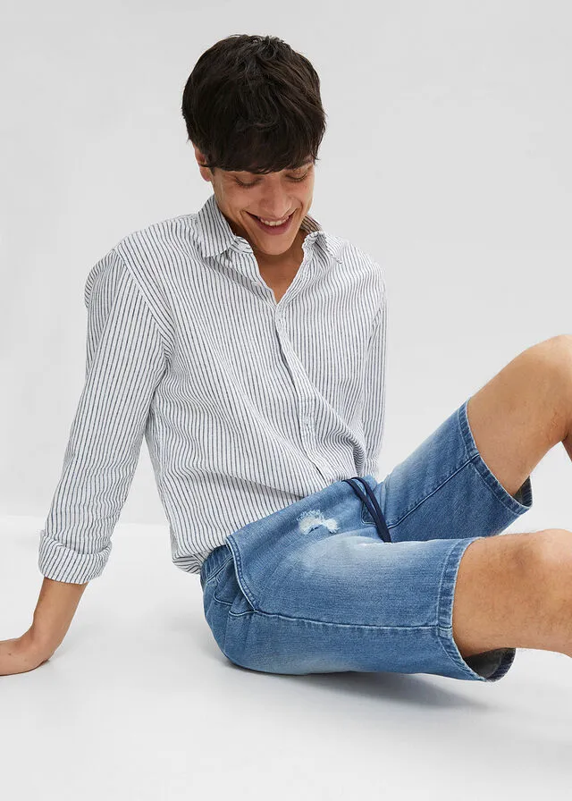 Denim Bermuda shorts with stretch waistband and distressed regular fit.