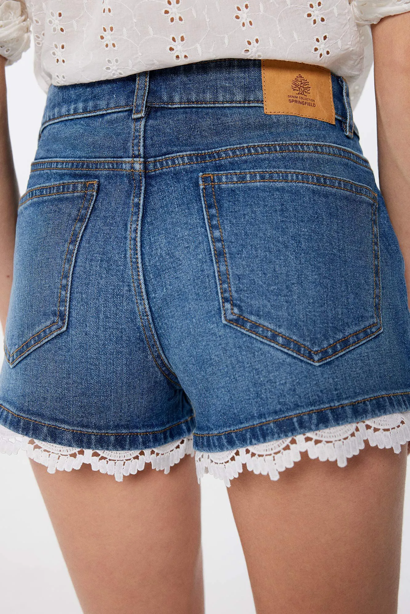 Denim shorts with lace design.