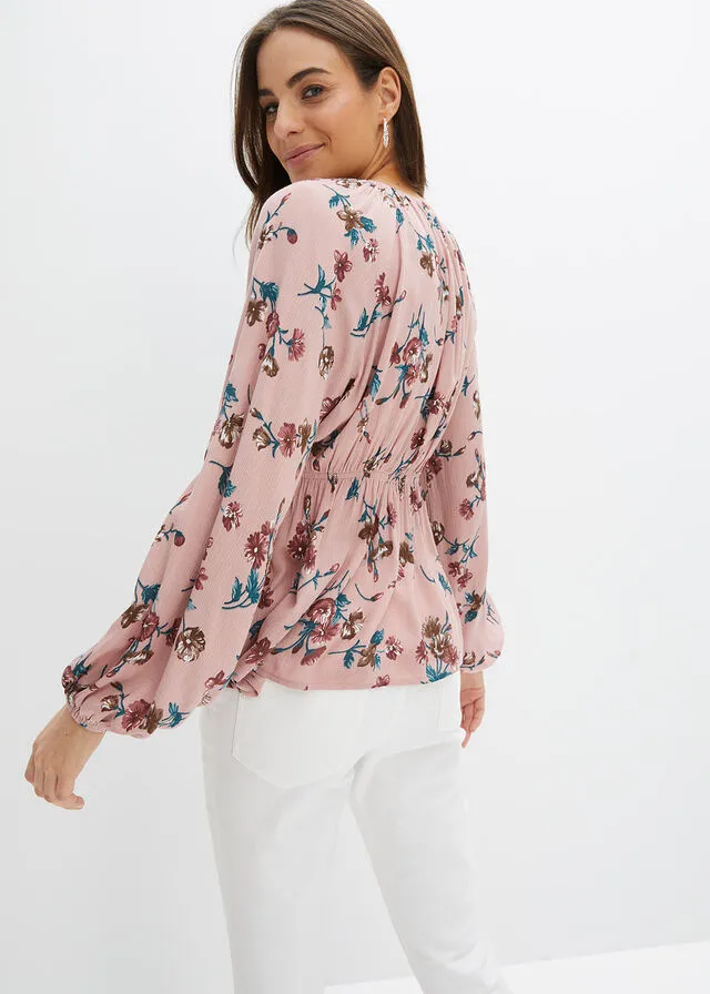 Wide pink floral blouse.
