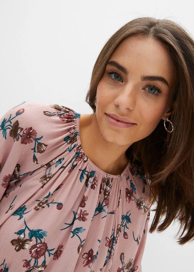 Wide pink floral blouse.
